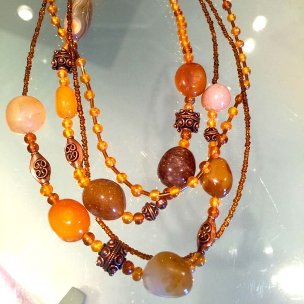 Multi strand brown gold necklace with glass beads